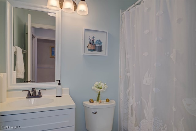 full bathroom with toilet and vanity