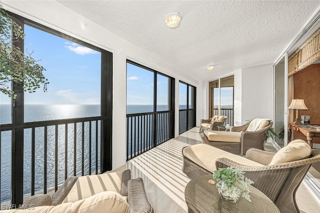 8171 Bay Colony Dr Unit 1902, Naples, FL 34108 - sunroom featuring a water view, a textured ceiling, and lofted ceiling