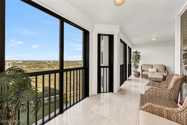 8171 Bay Colony Dr Unit 1902, Naples, FL 34108 - sunroom with a textured ceiling and marble tiled flooring
