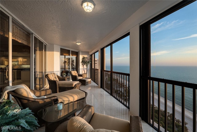 8171 Bay Colony Dr Unit 1902, Naples, FL 34108 - sunroom featuring a water view, a textured ceiling, and expansive windows
