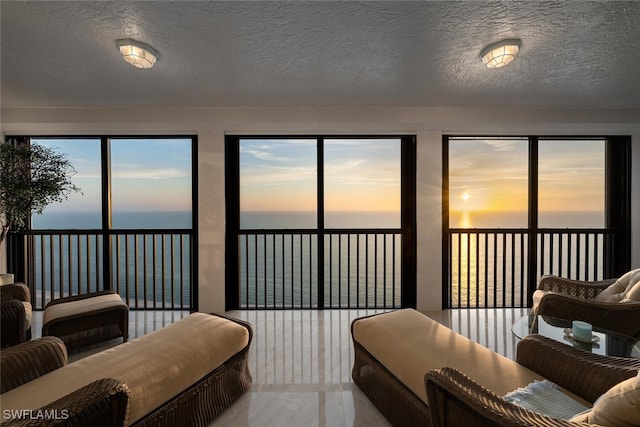 8171 Bay Colony Dr Unit 1902, Naples, FL 34108 - living area with a water view and a textured ceiling