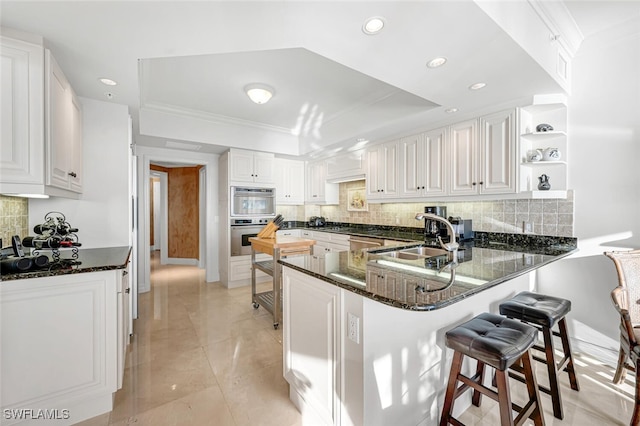 8171 Bay Colony Dr Unit 1902, Naples, FL 34108 - kitchen with a sink, a peninsula, backsplash, stainless steel appliances, and recessed lighting