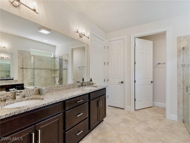 14016 Hawks Eye Ct, Estero, FL 33928 - full bath with baseboards, double vanity, a sink, and a shower stall