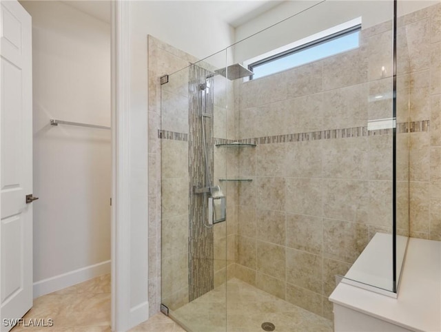 14016 Hawks Eye Ct, Estero, FL 33928 - bathroom featuring tile patterned flooring, baseboards, and a tile shower