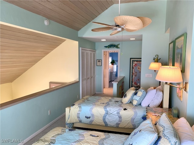 bedroom with carpet floors, a closet, baseboards, wooden ceiling, and vaulted ceiling