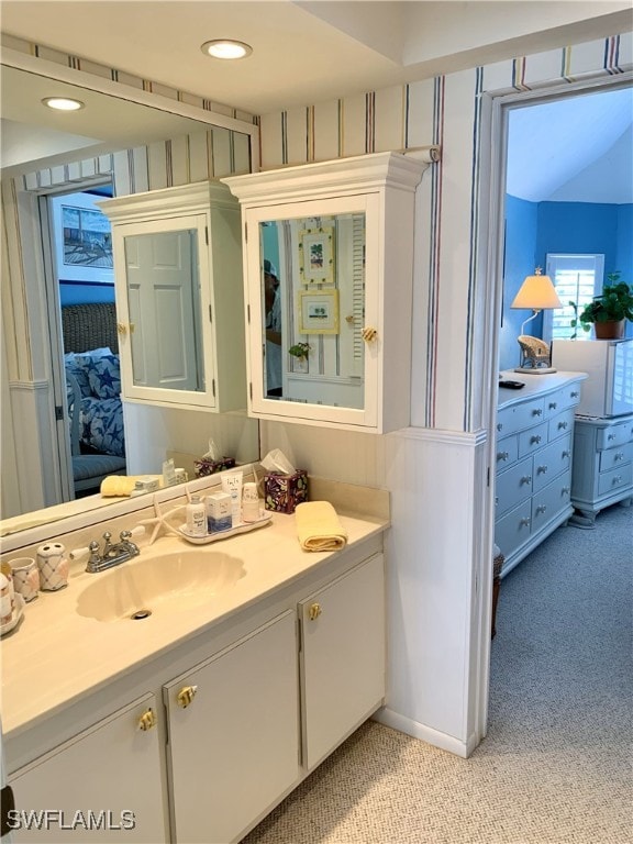 bathroom featuring vanity, recessed lighting, and ensuite bath