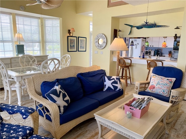 living room featuring a ceiling fan and wood finished floors