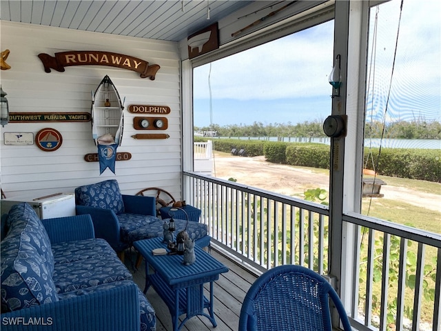 wooden deck featuring a water view
