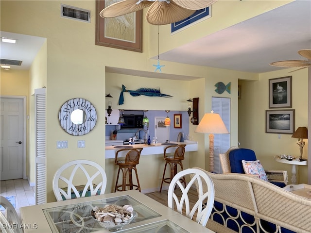 dining space featuring ceiling fan, visible vents, and wood finished floors