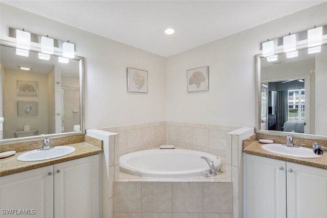 7920 Mahogany Run Ln Unit 1015, Naples, FL 34113 - bathroom featuring two vanities, a shower stall, a sink, and ensuite bath