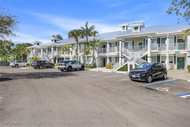 7920 Mahogany Run Ln Unit 1015, Naples, FL 34113 - view of property featuring stairway and uncovered parking