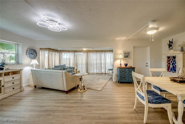 living area featuring light wood-style flooring and baseboards