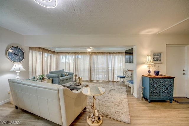 living area with light wood finished floors and baseboards