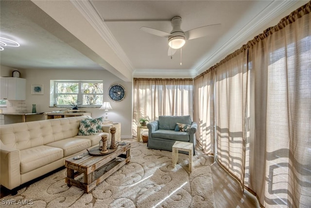 living room with crown molding, baseboards, a ceiling fan, and wood finished floors