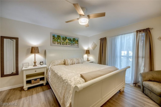 bedroom featuring light wood-style flooring, baseboards, and ceiling fan