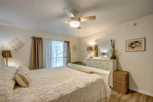 bedroom with light wood-style floors, baseboards, and a ceiling fan