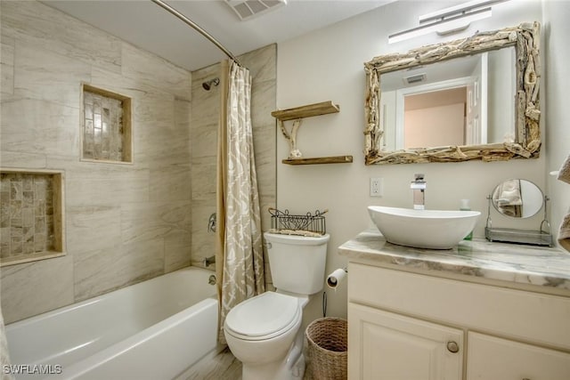bathroom with visible vents, toilet, vanity, and shower / bath combination with curtain