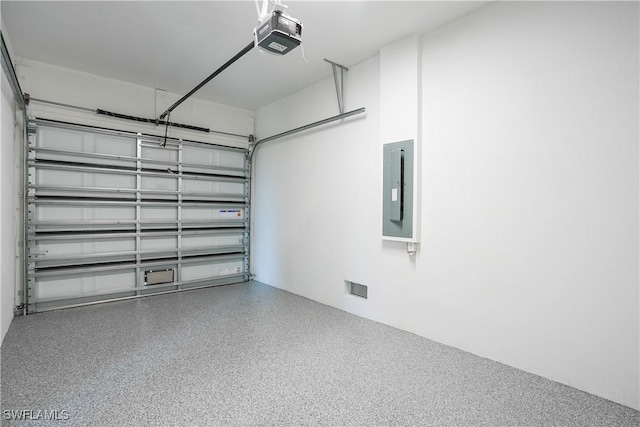 3384 Canal St, Naples, FL 34112 - garage featuring electric panel and a garage door opener