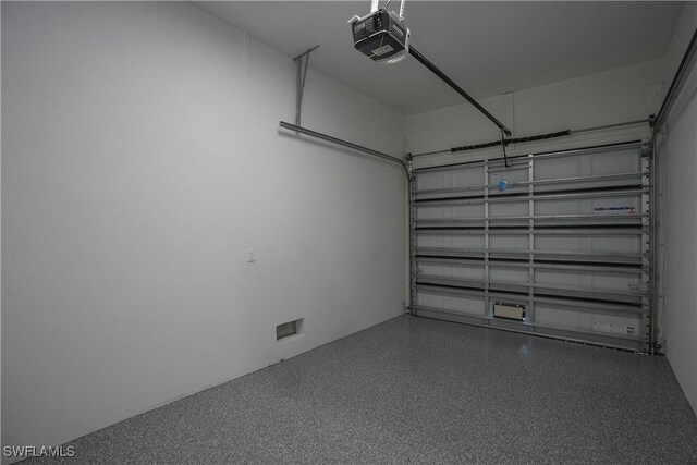 3384 Canal St, Naples, FL 34112 - garage featuring a garage door opener