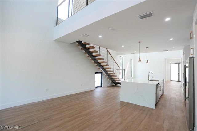 3384 Canal St, Naples, FL 34112 - kitchen with light wood finished floors, a sink, freestanding refrigerator, visible vents, and recessed lighting