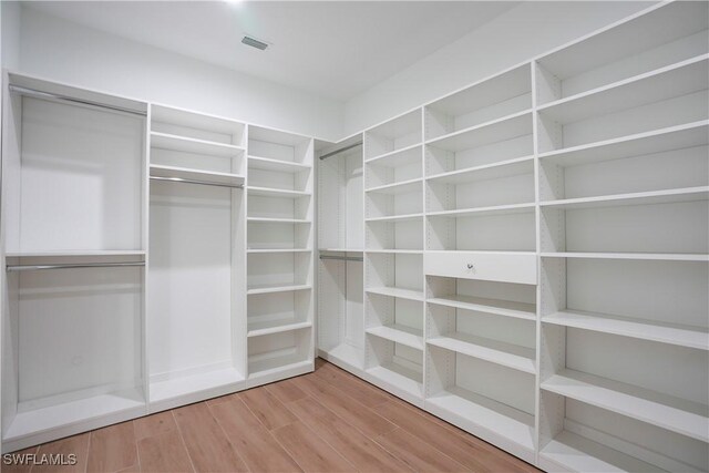3384 Canal St, Naples, FL 34112 - walk in closet featuring visible vents and wood finished floors