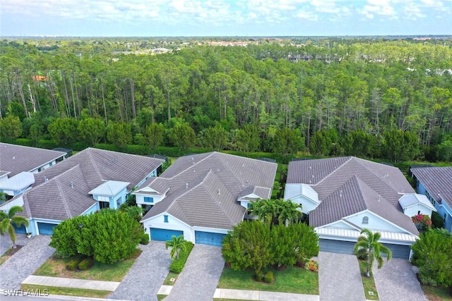 birds eye view of property featuring a forest view and a residential view