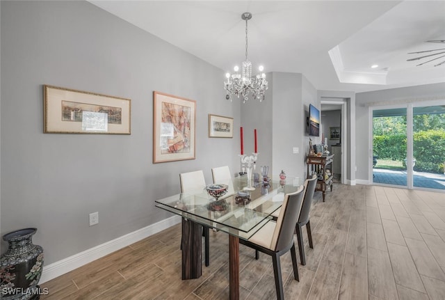 dining room featuring a tray ceiling, recessed lighting, a chandelier, wood finished floors, and baseboards