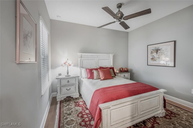bedroom with baseboards, ceiling fan, and wood finished floors