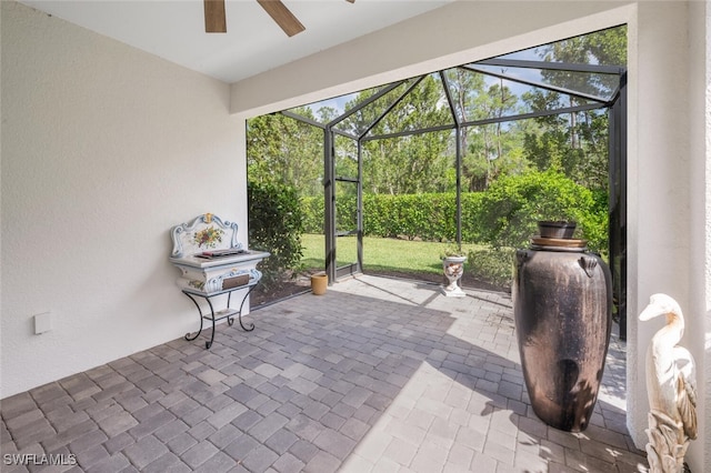 view of patio / terrace with ceiling fan and a lanai