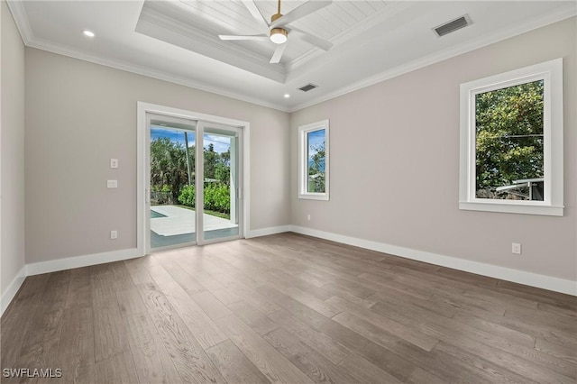1134 Trail Terrace Dr, Naples, FL 34103 - empty room with a raised ceiling, wood finished floors, crown molding, and visible vents