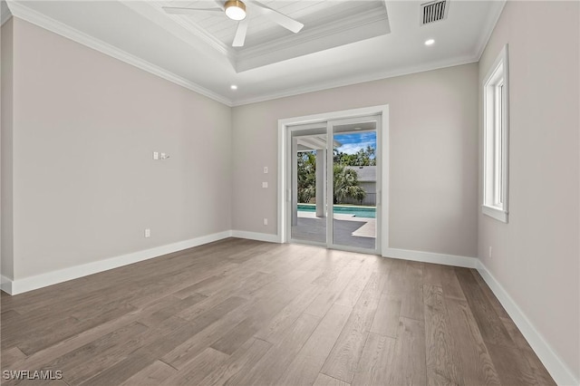 1134 Trail Terrace Dr, Naples, FL 34103 - empty room with crown molding, baseboards, a raised ceiling, visible vents, and wood finished floors