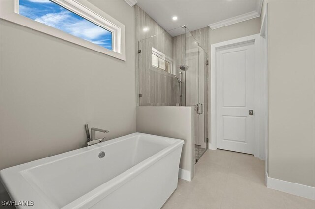 1134 Trail Terrace Dr, Naples, FL 34103 - full bathroom with ornamental molding, a freestanding tub, baseboards, and a shower stall