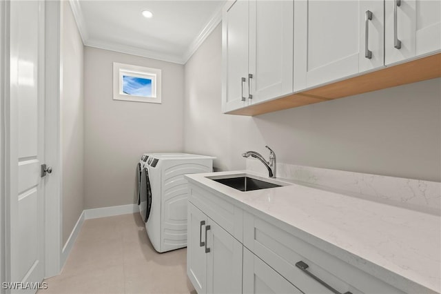 1134 Trail Terrace Dr, Naples, FL 34103 - washroom with crown molding, baseboards, a sink, cabinet space, and washer and clothes dryer