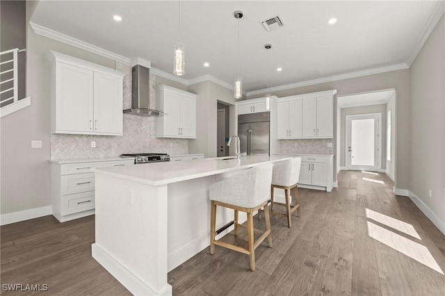 1134 Trail Terrace Dr, Naples, FL 34103 - kitchen featuring dark wood-style flooring, wall chimney exhaust hood, a spacious island, built in refrigerator, and stove
