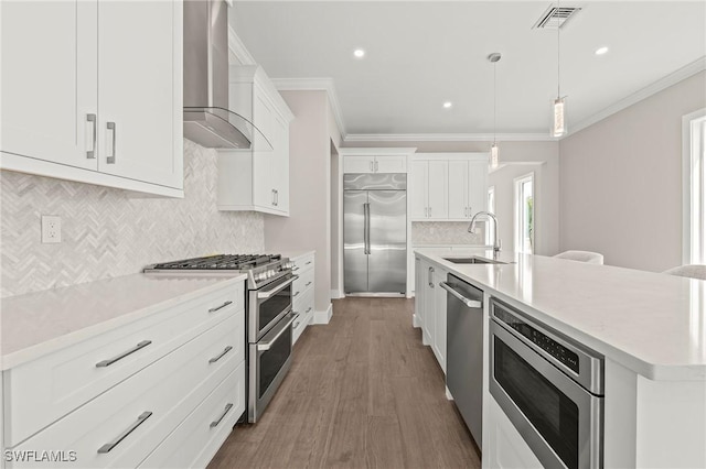 1134 Trail Terrace Dr, Naples, FL 34103 - kitchen with ornamental molding, a sink, built in appliances, and wall chimney range hood