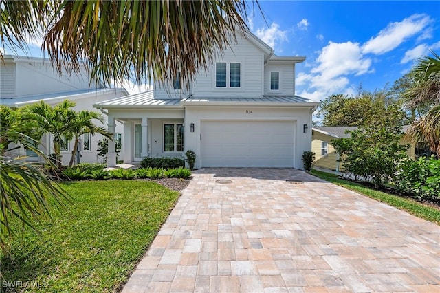 1134 Trail Terrace Dr, Naples, FL 34103 - view of front of home with decorative driveway, a standing seam roof, and metal roof