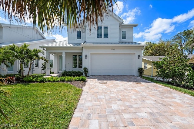 1134 Trail Terrace Dr, Naples, FL 34103 - view of front of home featuring a standing seam roof, an attached garage, metal roof, decorative driveway, and a front lawn