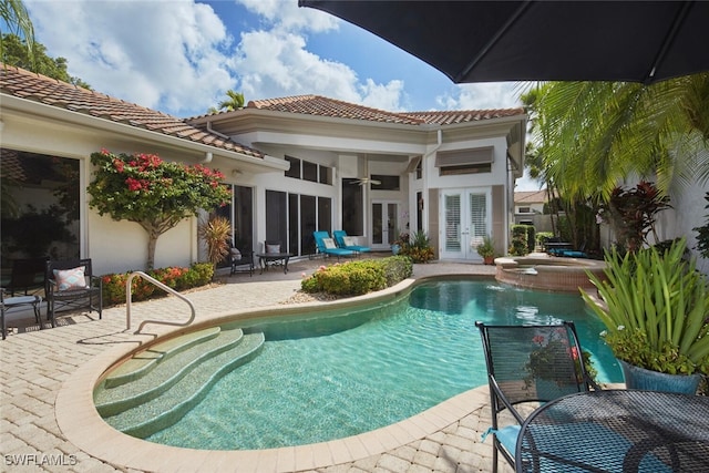 view of pool with outdoor dining space, french doors, a patio area, ceiling fan, and a pool with connected hot tub
