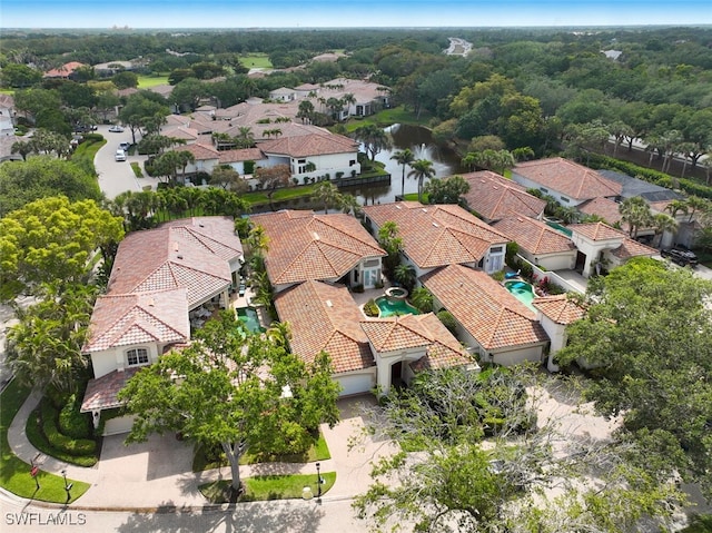 drone / aerial view featuring a water view and a residential view