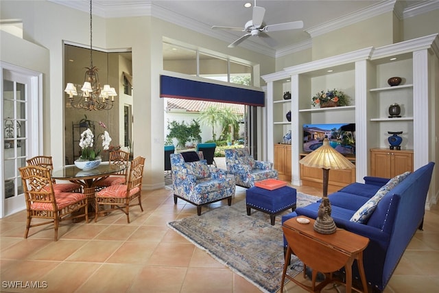 living area featuring crown molding, ceiling fan with notable chandelier, light tile patterned floors, and built in shelves