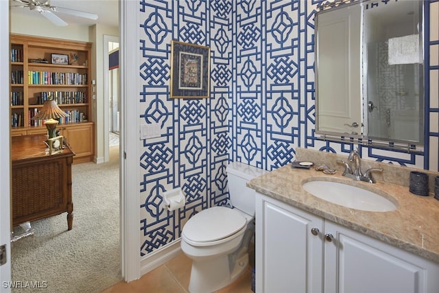 bathroom featuring tile patterned flooring, vanity, a ceiling fan, and toilet