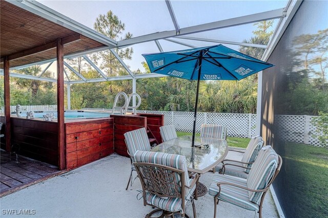 233 39th Ave NE, Naples, FL 34120 - view of patio with a hot tub and outdoor dining space