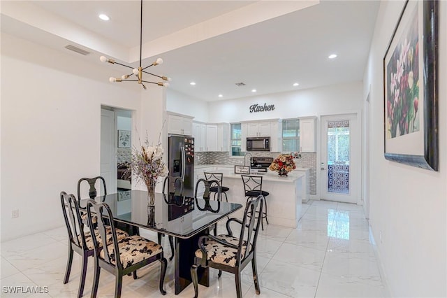 233 39th Ave NE, Naples, FL 34120 - dining room with light marble finish floors, a chandelier, and recessed lighting