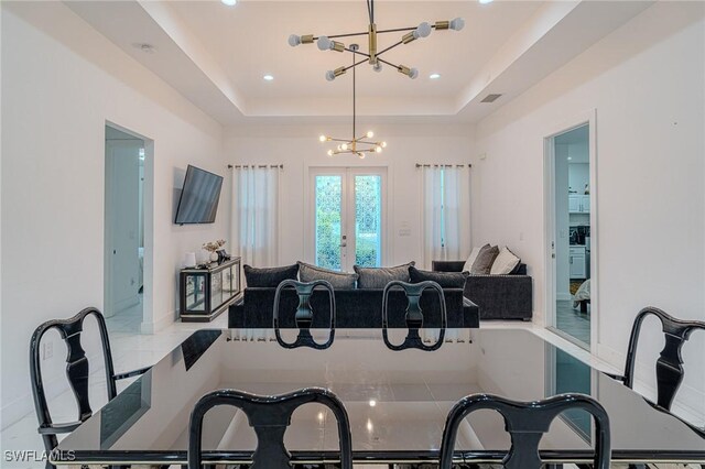 233 39th Ave NE, Naples, FL 34120 - dining space with a chandelier, a raised ceiling, recessed lighting, and french doors