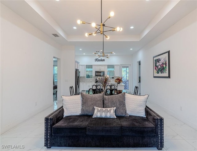233 39th Ave NE, Naples, FL 34120 - living room with a chandelier, light marble finish floors, a tray ceiling, recessed lighting, and baseboards
