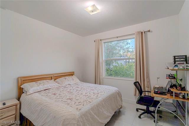 233 39th Ave NE, Naples, FL 34120 - bedroom featuring light marble finish floors and an office area