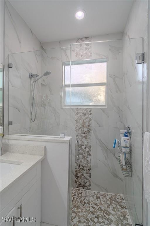 233 39th Ave NE, Naples, FL 34120 - bathroom featuring a marble finish shower, vanity, and recessed lighting