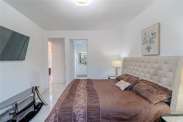 233 39th Ave NE, Naples, FL 34120 - bedroom featuring light marble finish flooring and ensuite bath