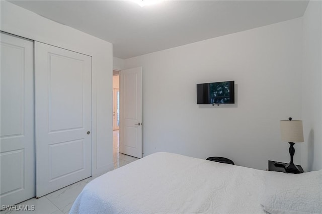 233 39th Ave NE, Naples, FL 34120 - bedroom with a closet and light marble finish floors