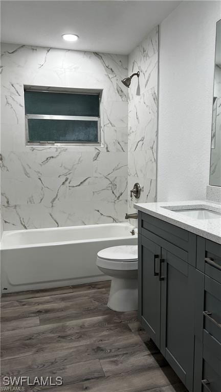 310 S Elm St, Labelle, FL 33935 - bathroom with tub / shower combination, toilet, wood finished floors, and vanity
